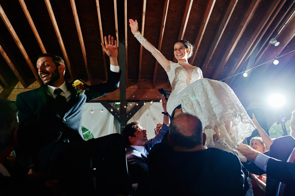 A couple dances the hora at their Jewish Wedding. 