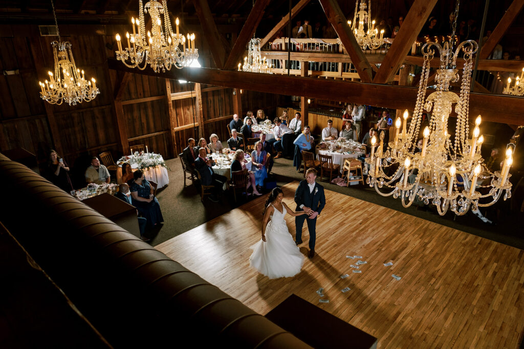 A couple enjoys their first dance together on the dance floor at Bell's Banquets, one of the best barn wedding venues in Pennsylvania. 